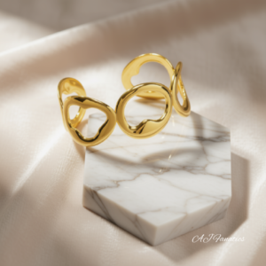 Curve of Cardioid Hearts Bangle Bracelet in gold-plated stainless steel, featuring open sculptural looping heart shapes.