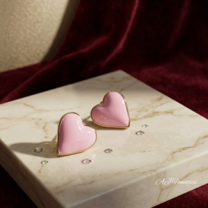 Candy Heart Charm Earrings in pastel pink enamel and rose gold-plated stainless steel, displayed as a glossy heart-shaped stud pair.