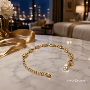 Minimalist Gilded Link Embrace bracelet from The Fusion Collection in polished gold stainless steel with rounded oval links, extender chain, and lobster clasp on a marble table.