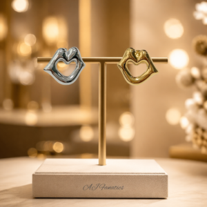 Kissing Hearts stainless steel gold and silver heart-shaped stud earrings on a classic earrings stand with glowing background.